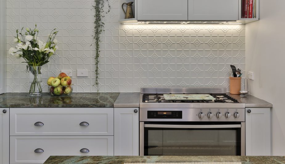 1950s Home Extension. White embossed splash back with dark marble bench tops